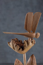 Dragonfly wooden carving resting on flower from Chinaberry parasite wood