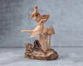 Hand-carved wooden bird on mushroom sculpture