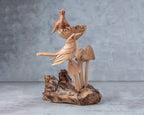 Hand-carved wooden bird on mushroom sculpture