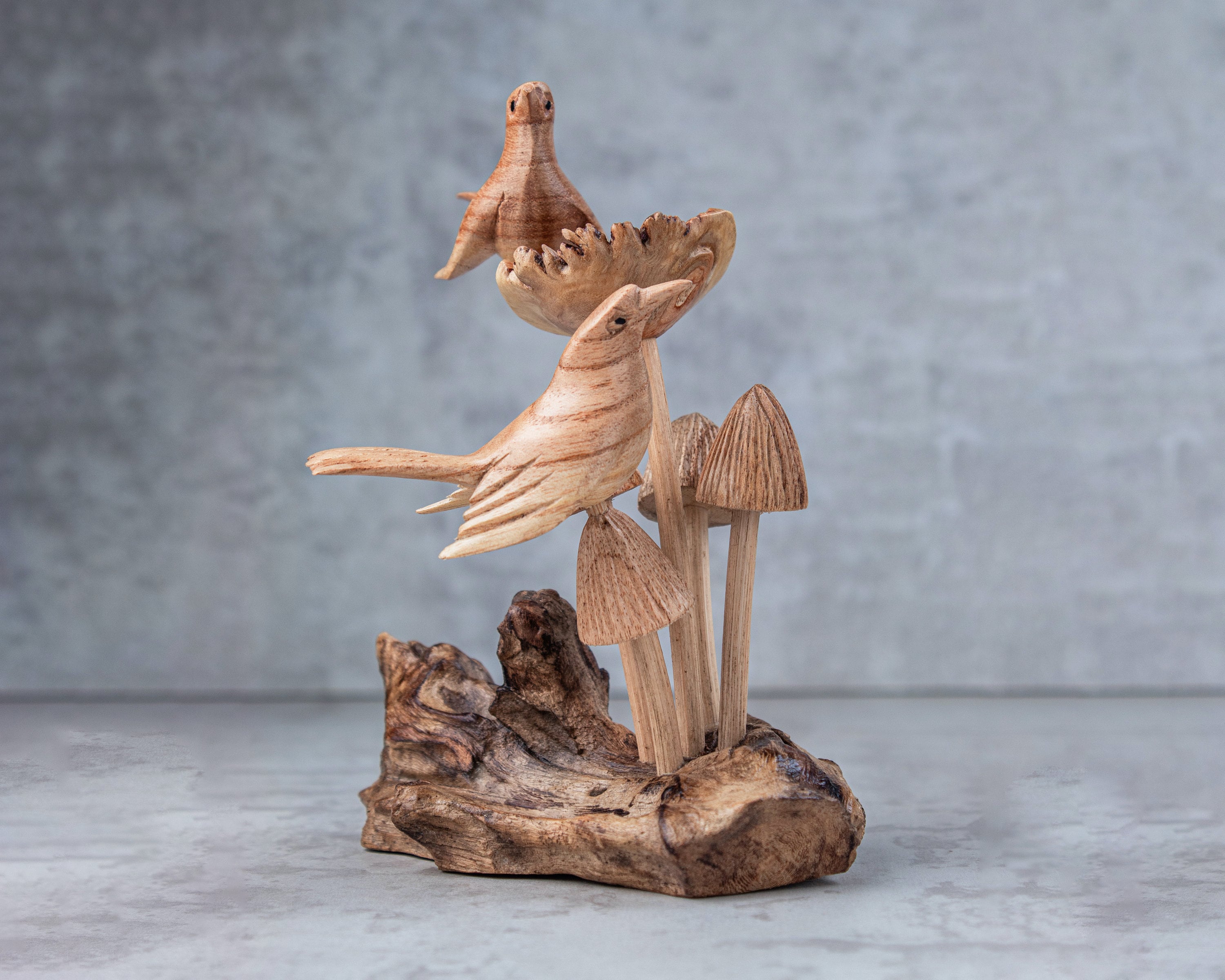 Hand-carved wooden bird on mushroom sculpture