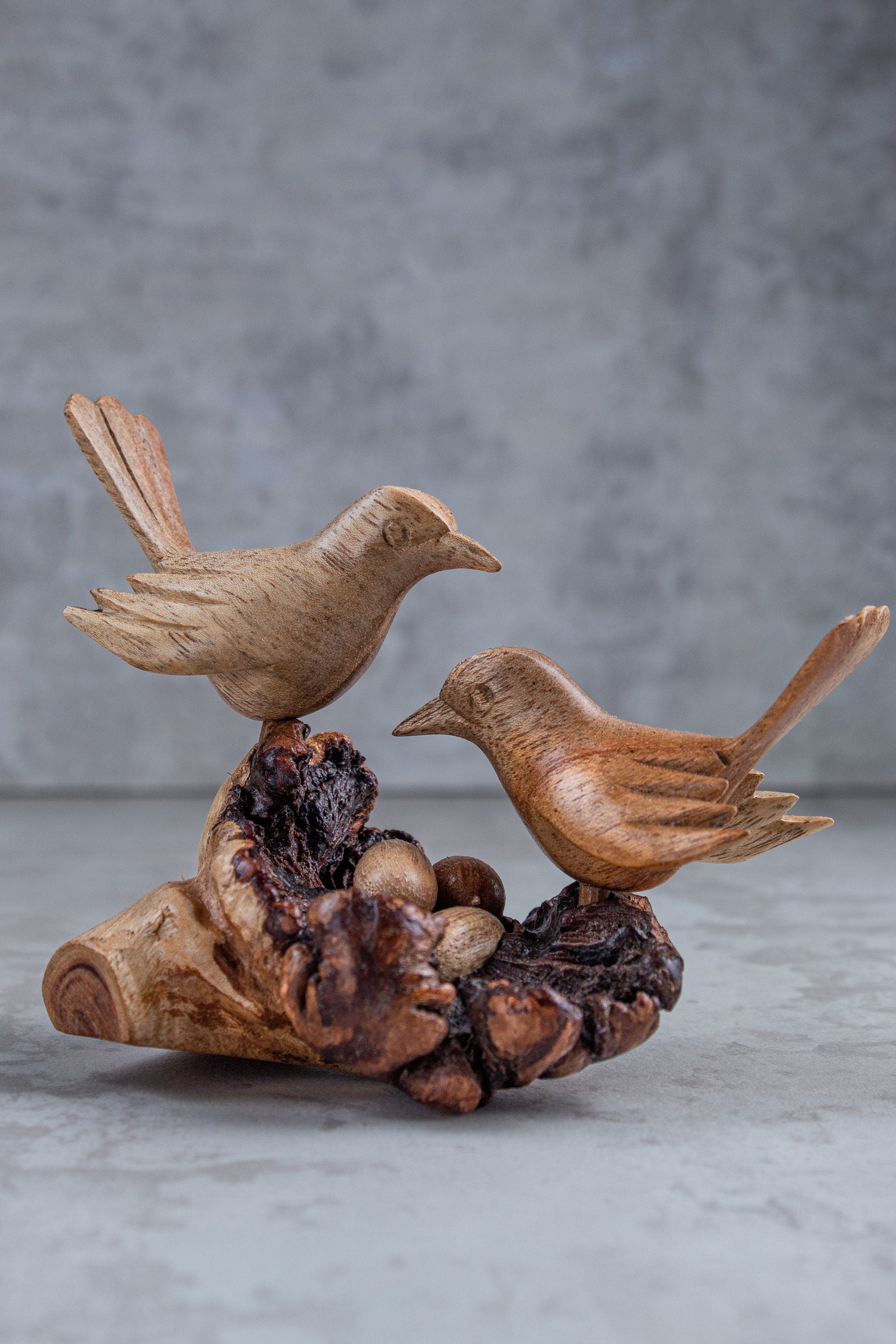 Hand-carved wooden birds on nest sculpture