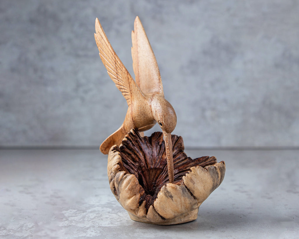 Hand-carved wooden hummingbird building nest sculpture