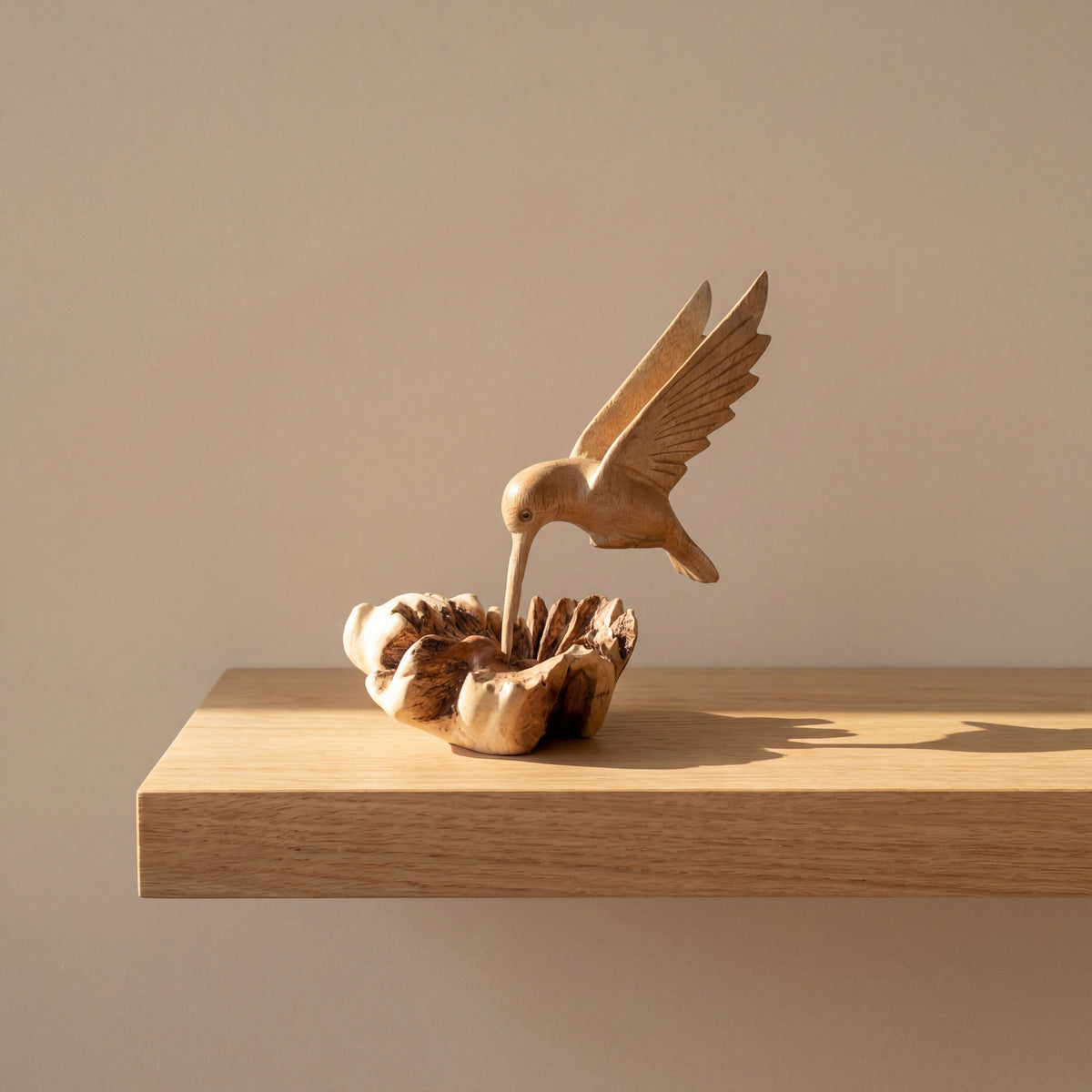 Hand-carved wooden hummingbird building nest sculpture
