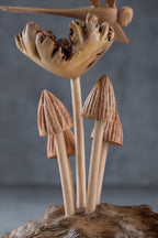 Wooden sculpture of mushrooms on a gray background