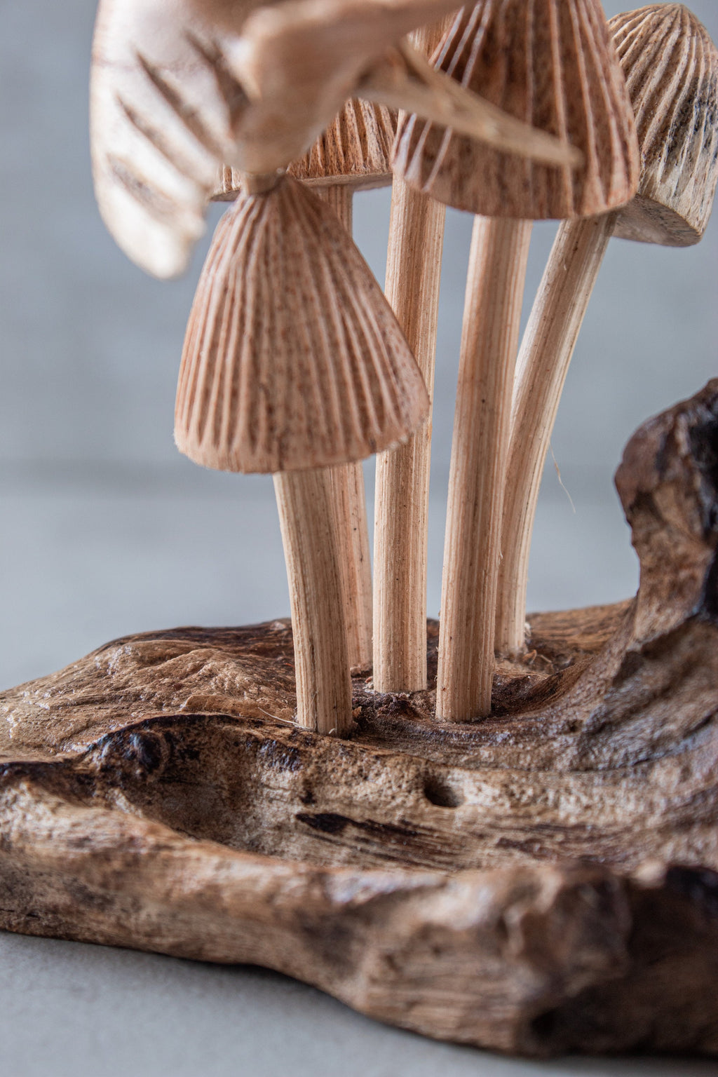 Wooden sculpture of a family of birds with children on a natural wood base