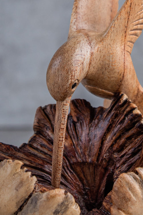 Hand-carved wooden hummingbird building nest sculpture